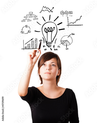 Photo: Young business woman drawing light bulb with various diagrams an Young business woman drawing light bulb with various diagrams an