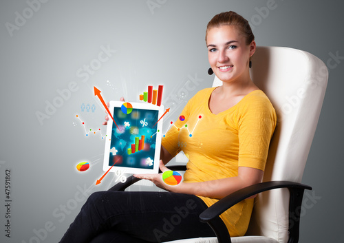Photo: woman holding modern tablet with colorful diagrams and graphs woman holding modern tablet with colorful diagrams and graphs