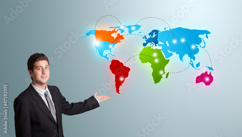 Photo: young man presenting colorful world map young man presenting colorful world map