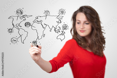 Photo: Young woman drawing a social map on whiteboard Young woman drawing a social map on whiteboard