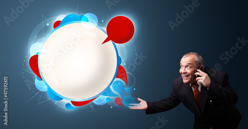 Photo: crazy businessman holding a phone and presenting abstract modern crazy businessman holding a phone and presenting abstract modern