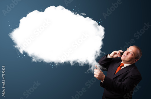 Photo: Businessman making phone call and presenting abstract cloud copy Businessman making phone call and presenting abstract cloud copy