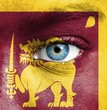 Human face painted with flag of Sri Lanka