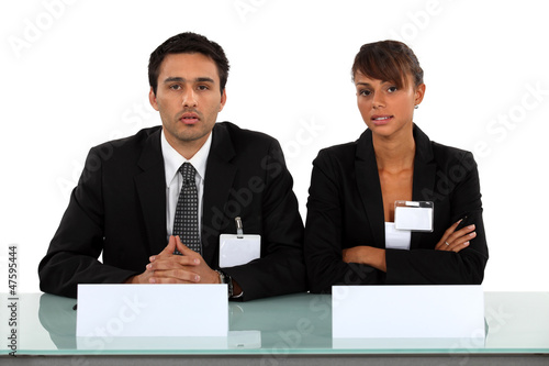 Photo: Two businesspeople wearing visitor badges Two businesspeople wearing visitor badges