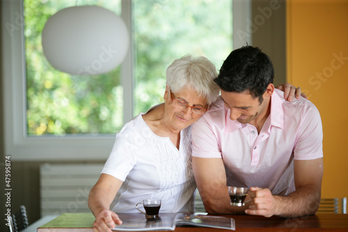 Photo: Senior woman drinking coffee with her son Senior woman drinking coffee with her son