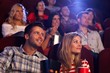 Foto: Young people sitting at movie theater Young people sitting at movie theater