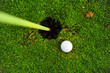 golf ball on lip of cup