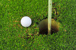 golf ball on lip of cup