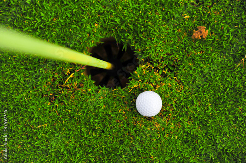 Photo: golf ball on lip of cup golf ball on lip of cup