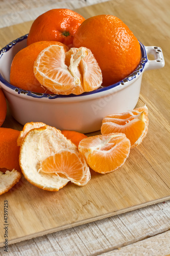 Photo: Fresh ripe mandarines on wooden background Fresh ripe mandarines on wooden background