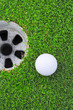 golf ball on lip of cup