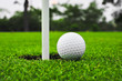golf ball on lip of cup