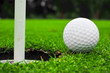 golf ball on lip of cup