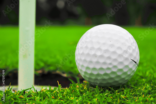 Photo: golf ball on lip of cup golf ball on lip of cup
