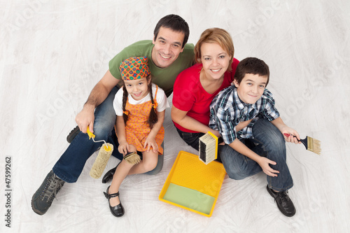 Photo: Family with two kids ready to pait their home Family with two kids ready to pait their home