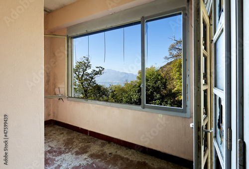 Photo: abandoned building, empty room with window abandoned building, empty room with window