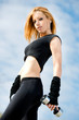Beautiful fit woman exercising  outdoors over a sky background