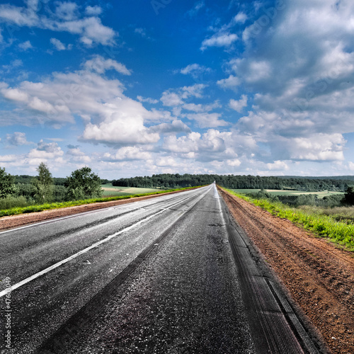 Photo: Country road disappearing into the distance. Panorama. Country road disappearing into the distance. Panorama.