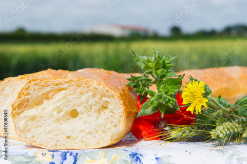 Photo: Fresh bread and grain ears outdoor Fresh bread and grain ears outdoor