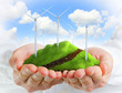 Photo: Male hands holding a green hill with wind turbines Male hands holding a green hill with wind turbines