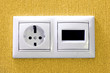 Plugs in electric and phone  socket.