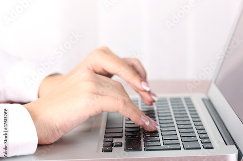 Photo: Hands typing on laptop keyboard close up Hands typing on laptop keyboard close up