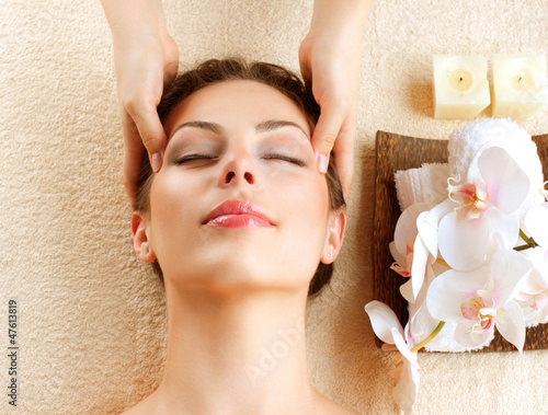 Photo: Spa Massage. Young Woman Getting Facial Massage Spa Massage. Young Woman Getting Facial Massage