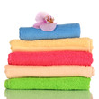 Stack of towels with fragrant flower isolated on white