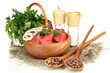 Raw beef meat in bowl with herbs and spices isolated on white