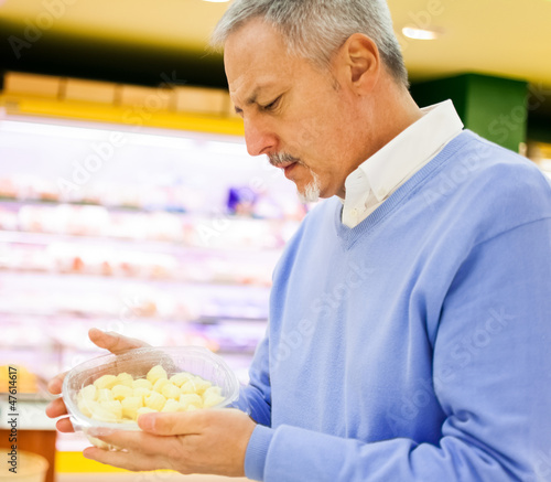 Photo: Man shopping in a supermarket Man shopping in a supermarket