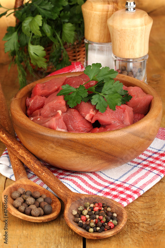 Photo: Raw beef meat with herbs and spices Raw beef meat with herbs and spices