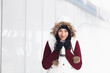 Photo: Beautiful smiling girl holding thermos in snowy winter outdoors Beautiful smiling girl holding thermos in snowy winter outdoors