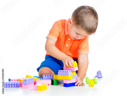 Photo: cheerful child boy playing with construction set over white back cheerful child boy playing with construction set over white back