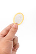 Photo: Hand with condom isolated on white Hand with condom isolated on white