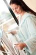 Photo: Beautiful woman hanging freshly washed clothes on the rack Beautiful woman hanging freshly washed clothes on the rack