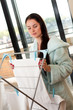 Beautiful woman hanging freshly washed clothes on the rack