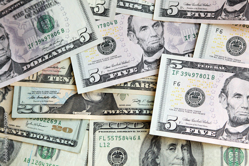 Photo: Heap of US dollars, notes of different values, money background Heap of US dollars, notes of different values, money background