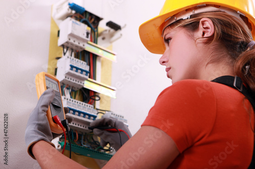 Photo: Woman measuring electrical current Woman measuring electrical current