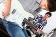 Landscape picture of guys with guitars and drums