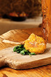 deer cutlet served on a wooden cutting board
