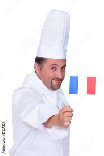 Photo: Cook holding French flag Cook holding French flag