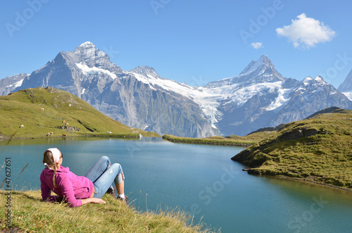 Photo: Traveler in the Alpine meadow. Jungfrau region, Switzerland Traveler in the Alpine meadow. Jungfrau region, Switzerland