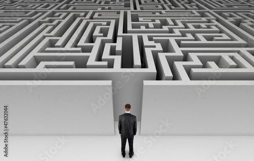 Illustration: Businessman in front of a huge maze Businessman in front of a huge maze