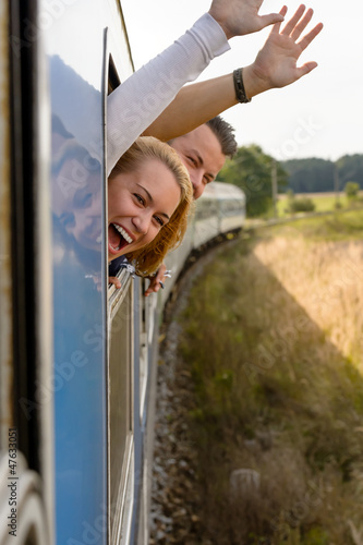 Photo: Couple screaming out train window waving happy Couple screaming out train window waving happy
