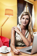 Photo: young successful business woman working at home / office young successful business woman working at home / office