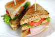 Toasted club sandwiches, tomato, meat and chees.