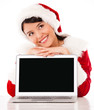 Thoughtful female Santa with laptop