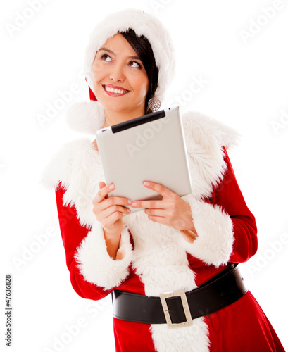 Photo: Thoughtful Mrs Claus with a tablet Thoughtful Mrs Claus with a tablet