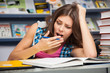 Beautiful female student in a library
