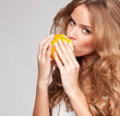 Portrait of a young beautiful woman with orange 